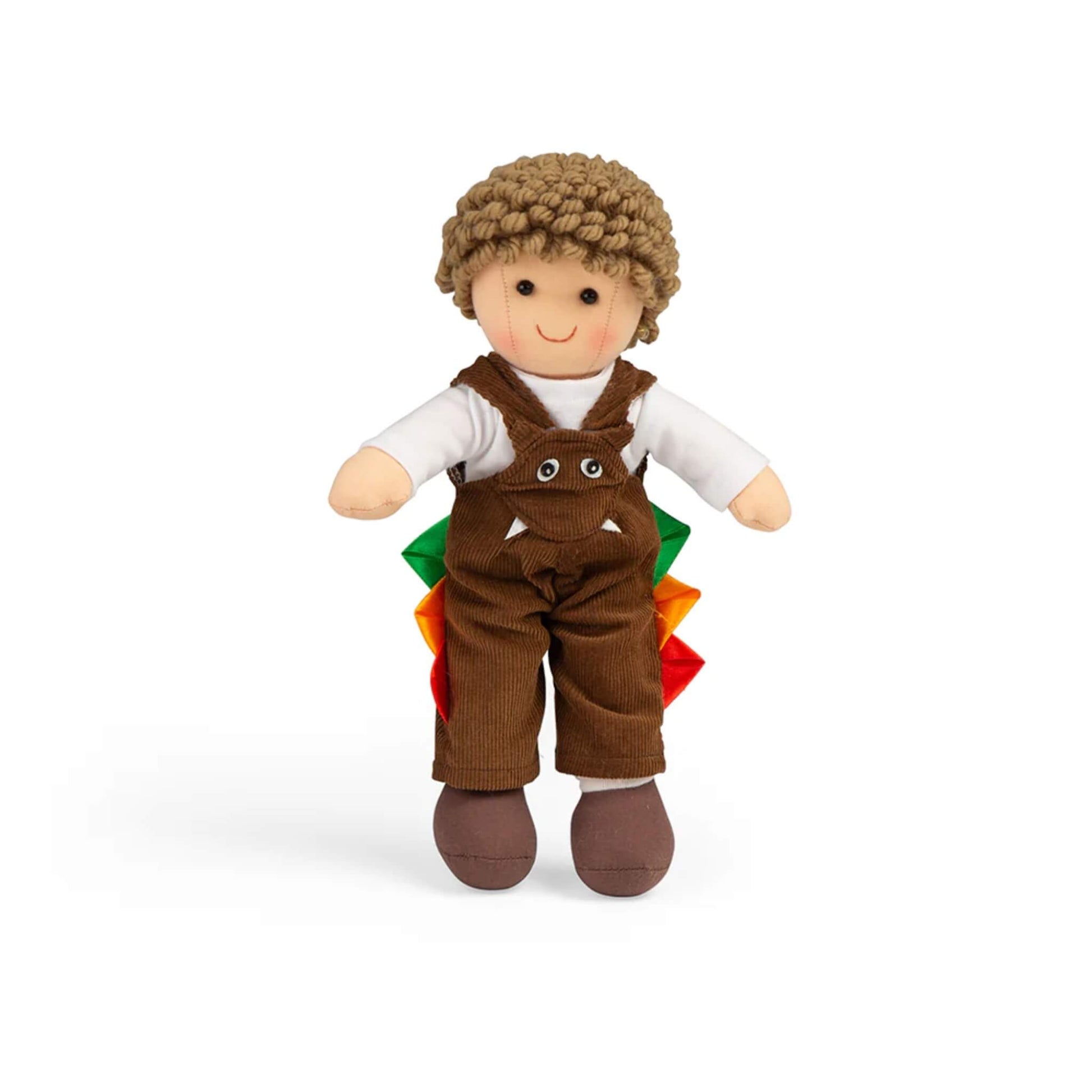 Soft Bigjigs Toys Jack ragdoll with curly hair, wearing a brown dinosaur-themed dungaree outfit with colourful spikes and a friendly monster face.