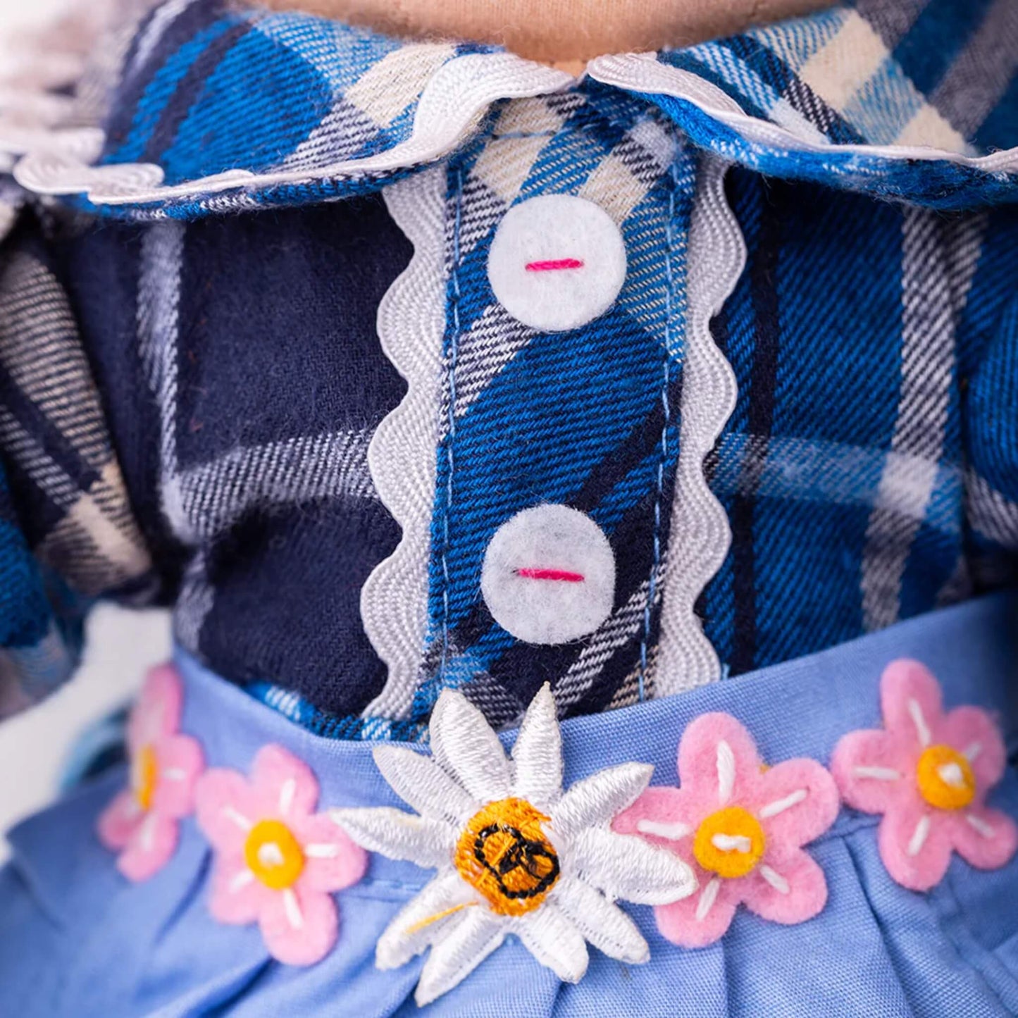 Close-up of Katie Doll’s plaid collar with white scalloped trim and decorative felt buttons for added texture and charm.