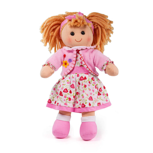 Bigjigs Toys soft Kelly ragdoll with ginger yarn hair, pink floral dress and cardigan, and pink shoes, standing upright against a plain background.