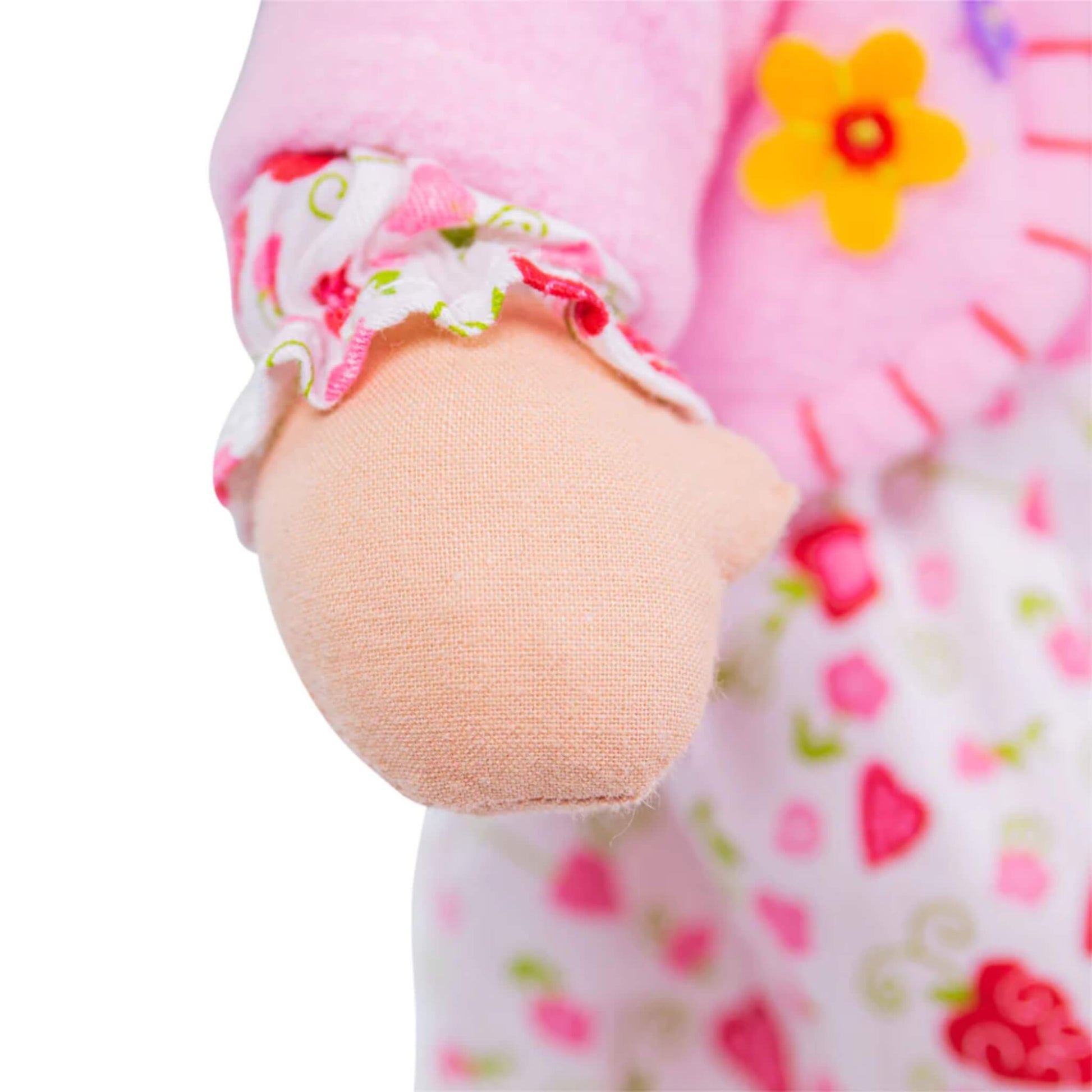 Soft doll hand with visible stitching and floral-patterned sleeve gathered with pink trim.