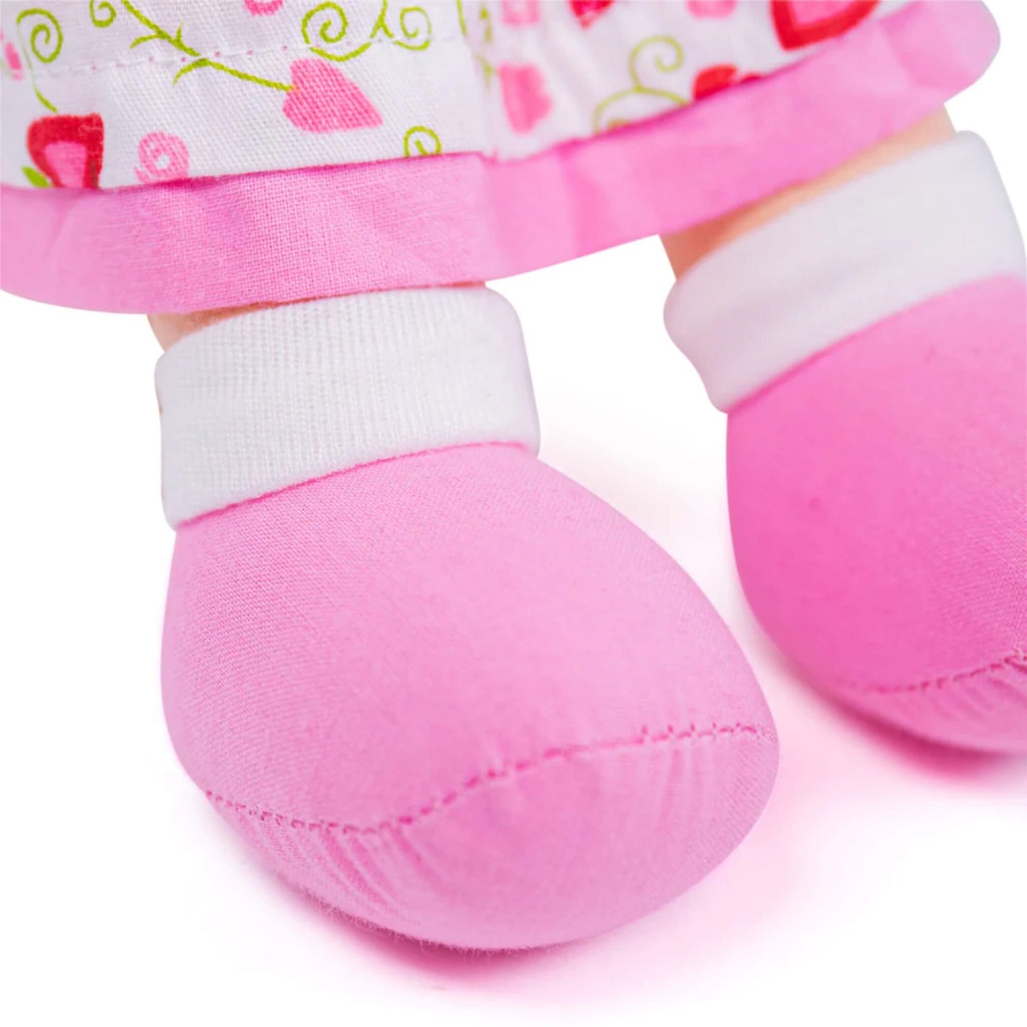 Kelly’s plush pink shoes with white ankle cuffs, showing rounded shape and stitching details.