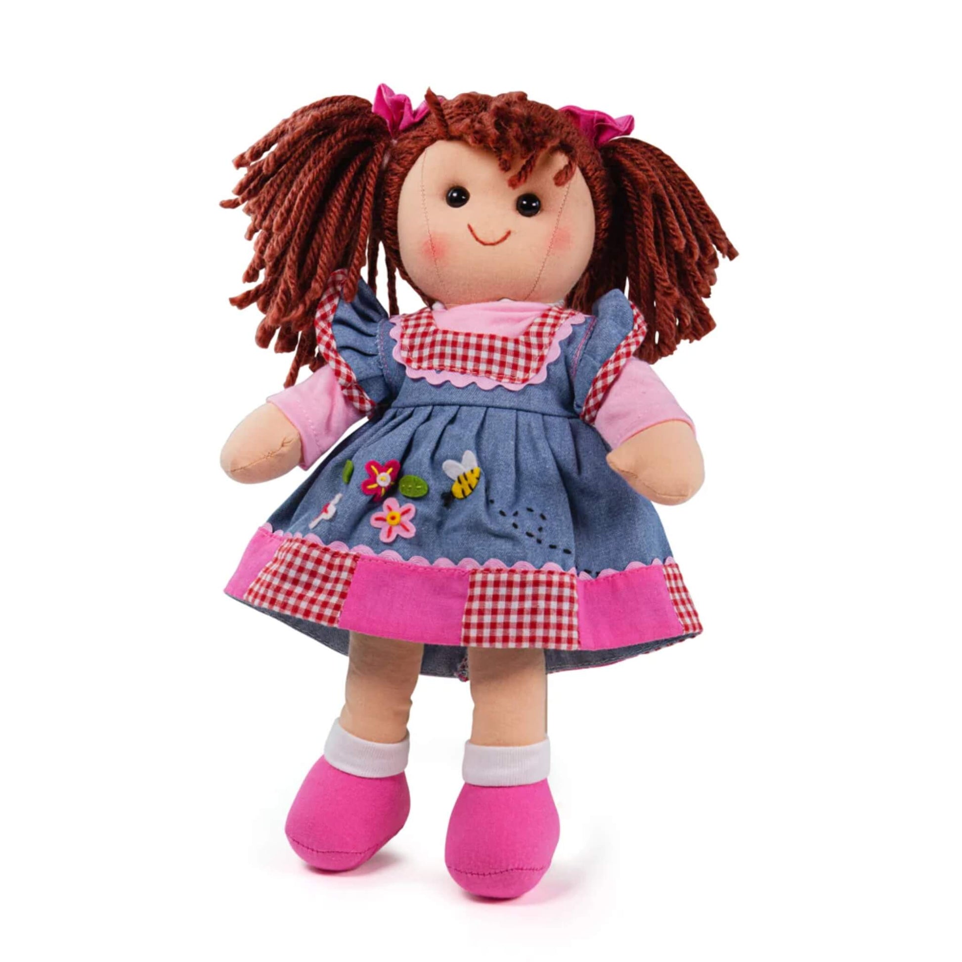 Bigjigs Toys Melody Doll, shown standing in a denim-effect dress with red gingham panels, floral appliqué and pink shoes with white socks.