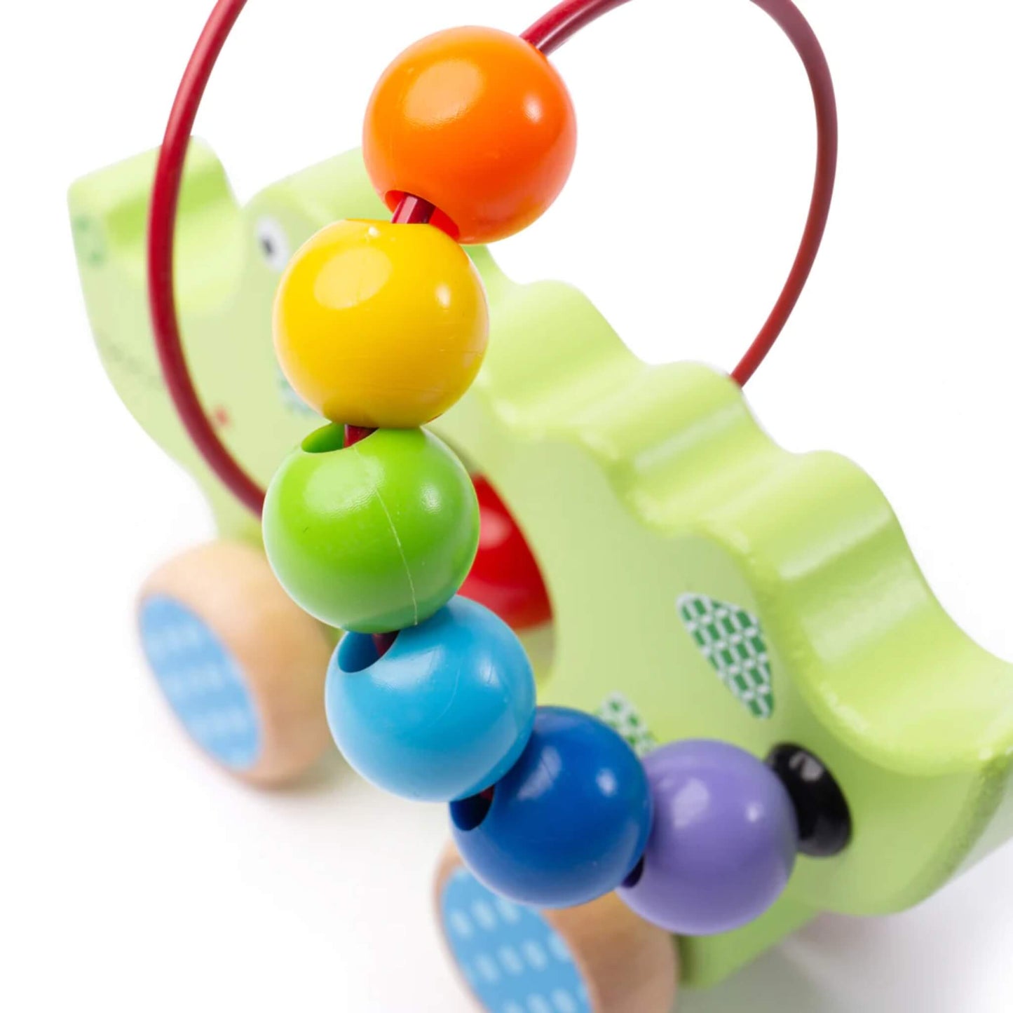 Side view of the colourful bead maze, showing orange, yellow, green, blue, and purple beads threaded on a red curved wire.