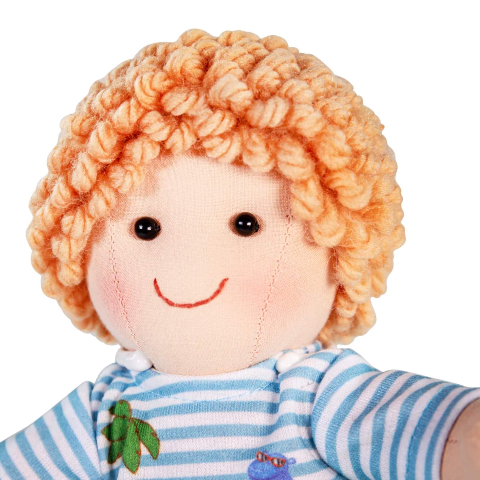 Close-up of Robin doll’s friendly embroidered smile, rosy cheeks and textured curly hair.