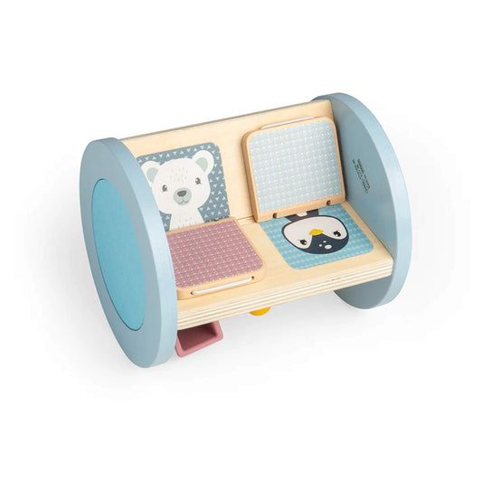 Inside view of the toy showing illustrated flip panels with a polar bear and penguin, placed next to a textured pad for tactile play.