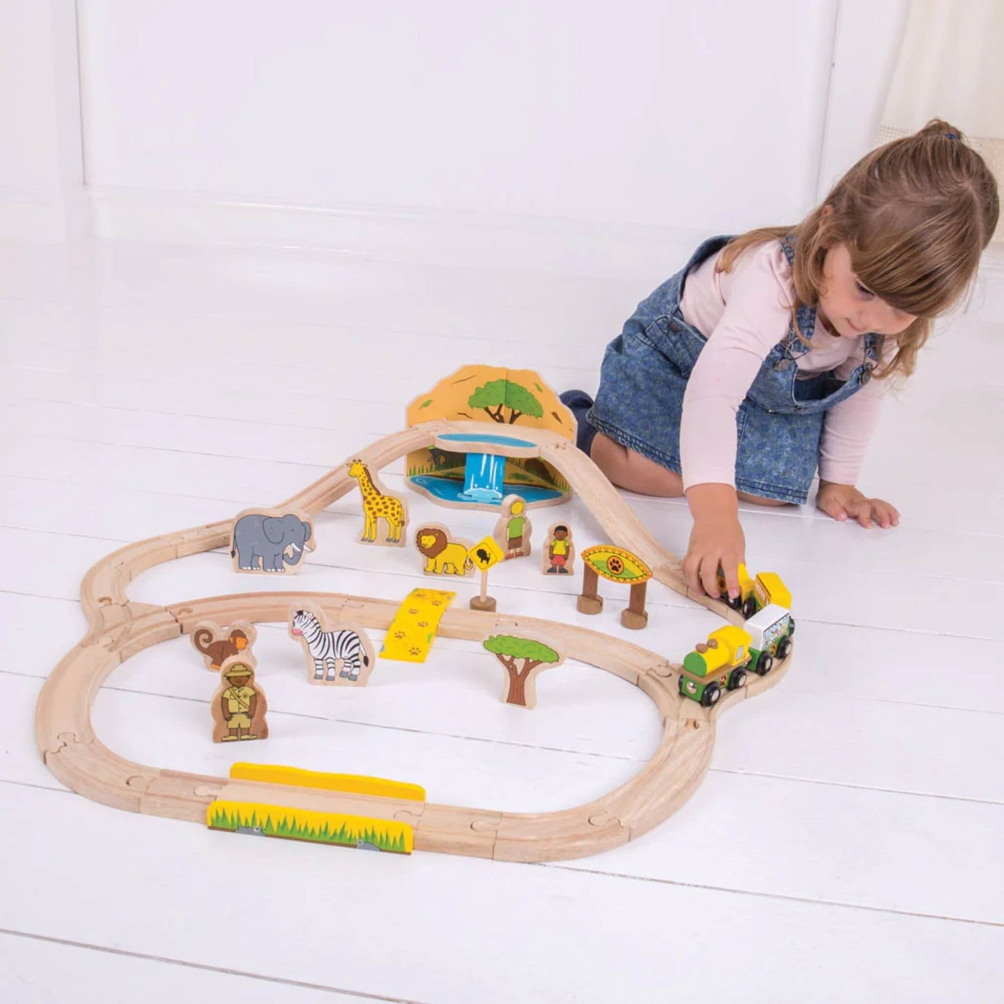 Child pushing the safari train around the track, exploring different features of the playset.