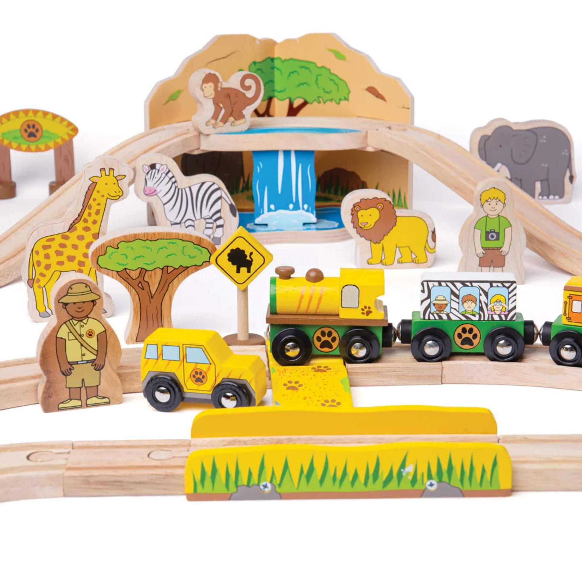 Close-up of the wooden safari scene with giraffe, zebra, lion, ranger, and yellow safari train in front of a mountain and waterfall tunnel.