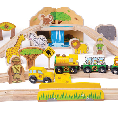 Close-up of the wooden safari scene with giraffe, zebra, lion, ranger, and yellow safari train in front of a mountain and waterfall tunnel.