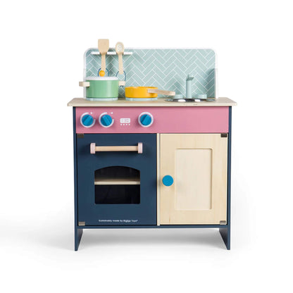 Front view of the Simply Scandi Kitchen showing pink, navy, and cream detailing with wooden knobs and hob dials.