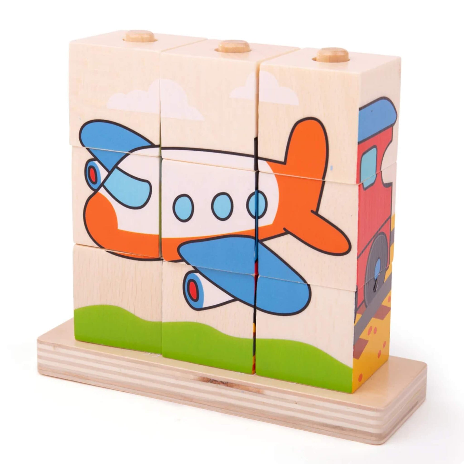 Wooden puzzle blocks forming a bright orange and white aeroplane flying across a green hill and cloudy sky, all nine blocks aligned on the base.