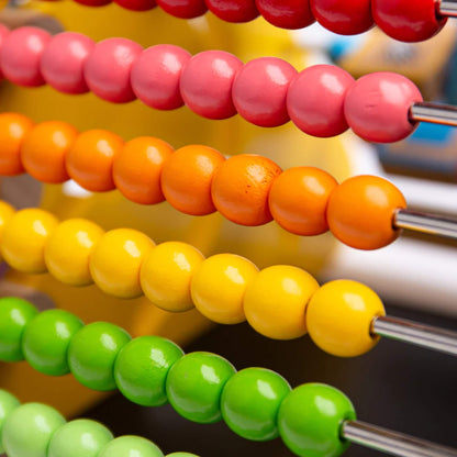 Close-up of bright wooden abacus beads on metal rods.