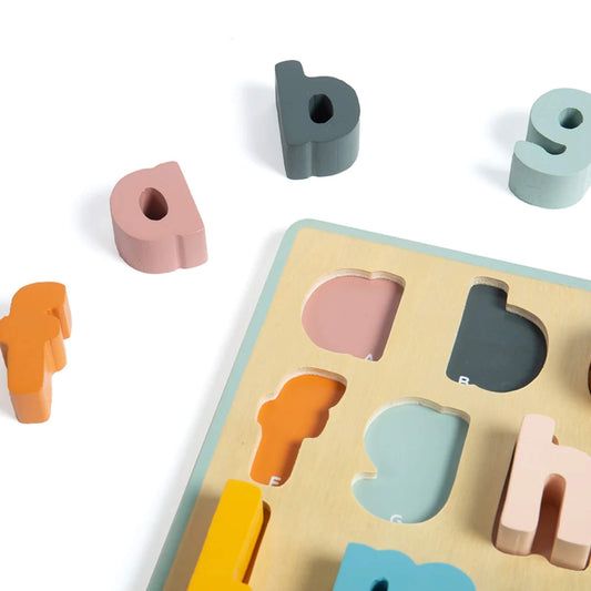 Close-up of pastel wooden lowercase letters on the alphabet puzzle, showing matching slots and bright, child-friendly colours.