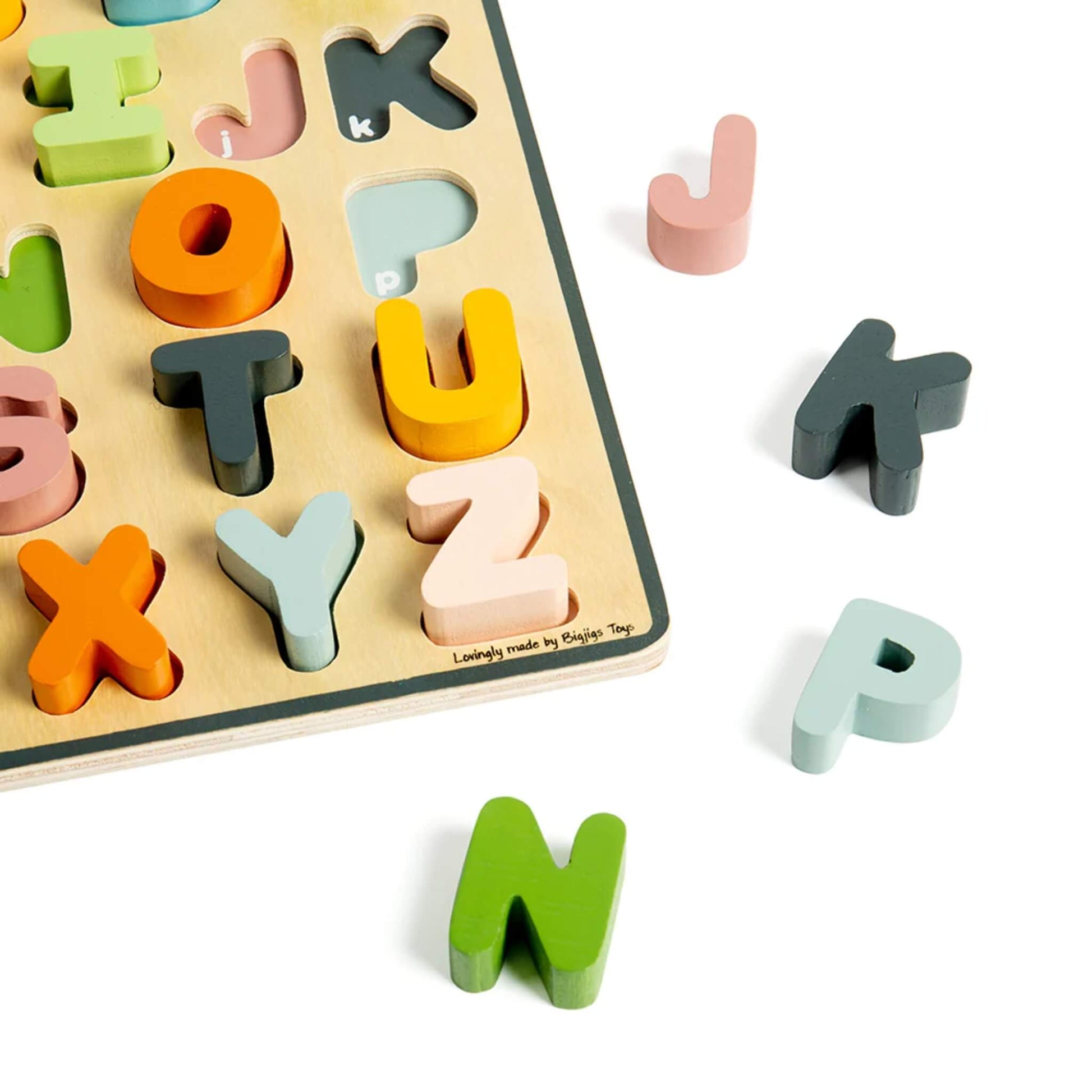 Close-up of pastel wooden letters on the alphabet puzzle, showing matching slots and bright, child-friendly colours.
