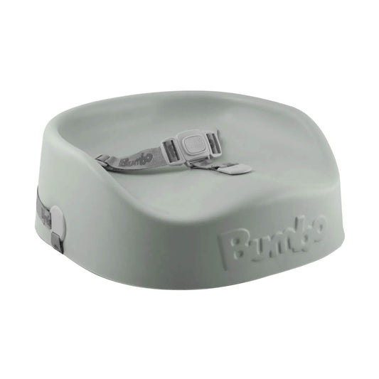 Bumbo booster seat in soft sage green with integrated safety harness and contoured foam seat on a white background.