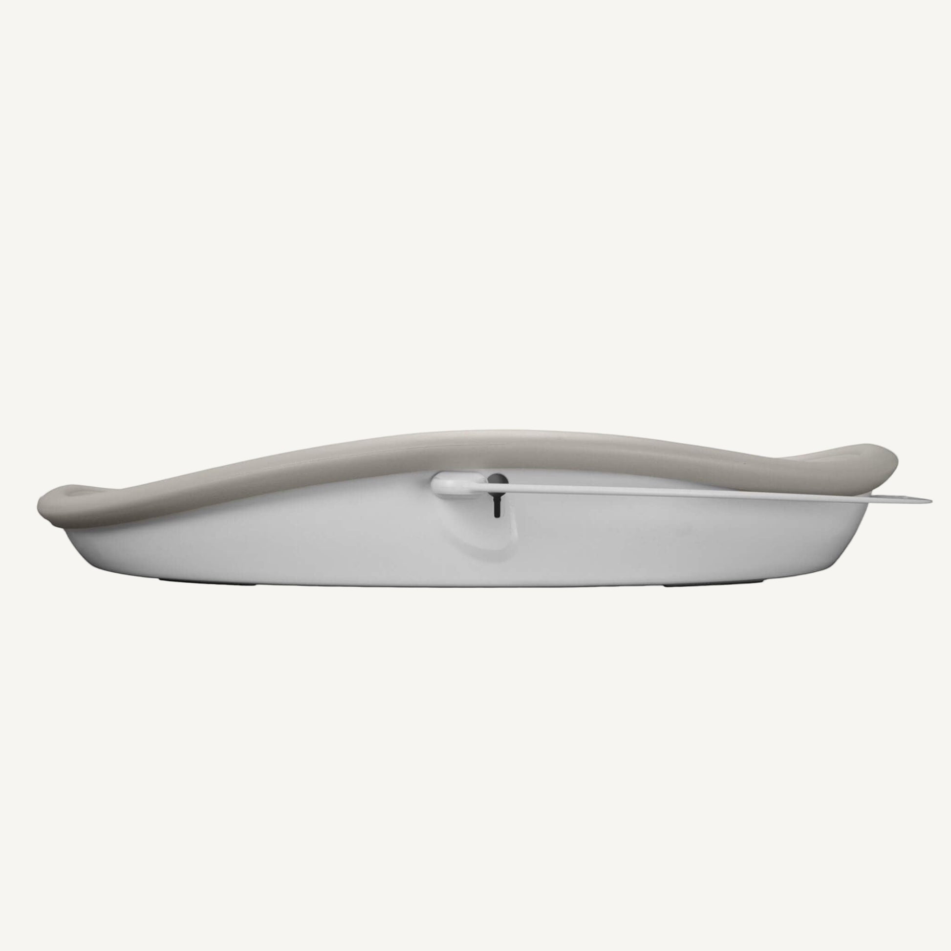 Side view of the Bumbo Max Changing Pad in Taupe showing slim, curved foam profile.