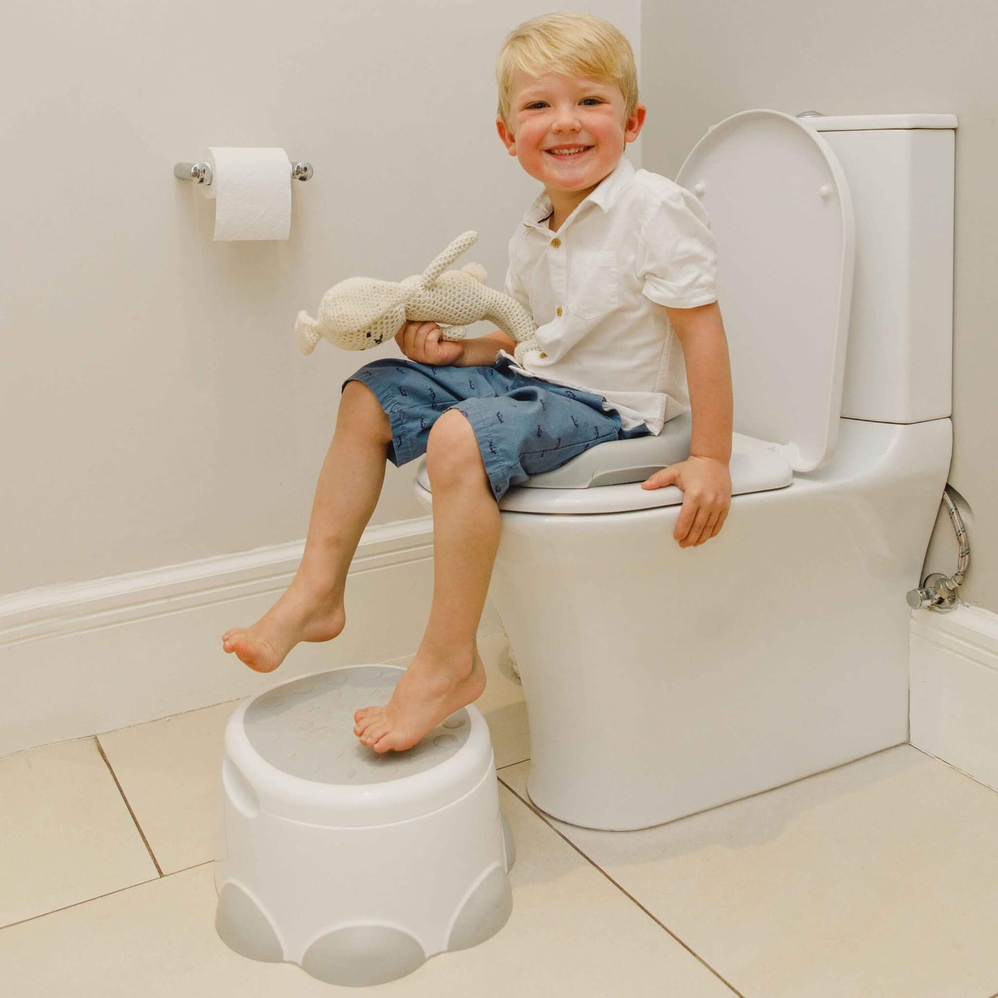 Young boy using Bumbo Step ‘n Potty as step and toilet trainer.