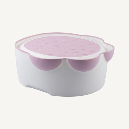Bumbo Step ‘n Potty in Cradle Pink with lid neatly stowed underneath for step use.