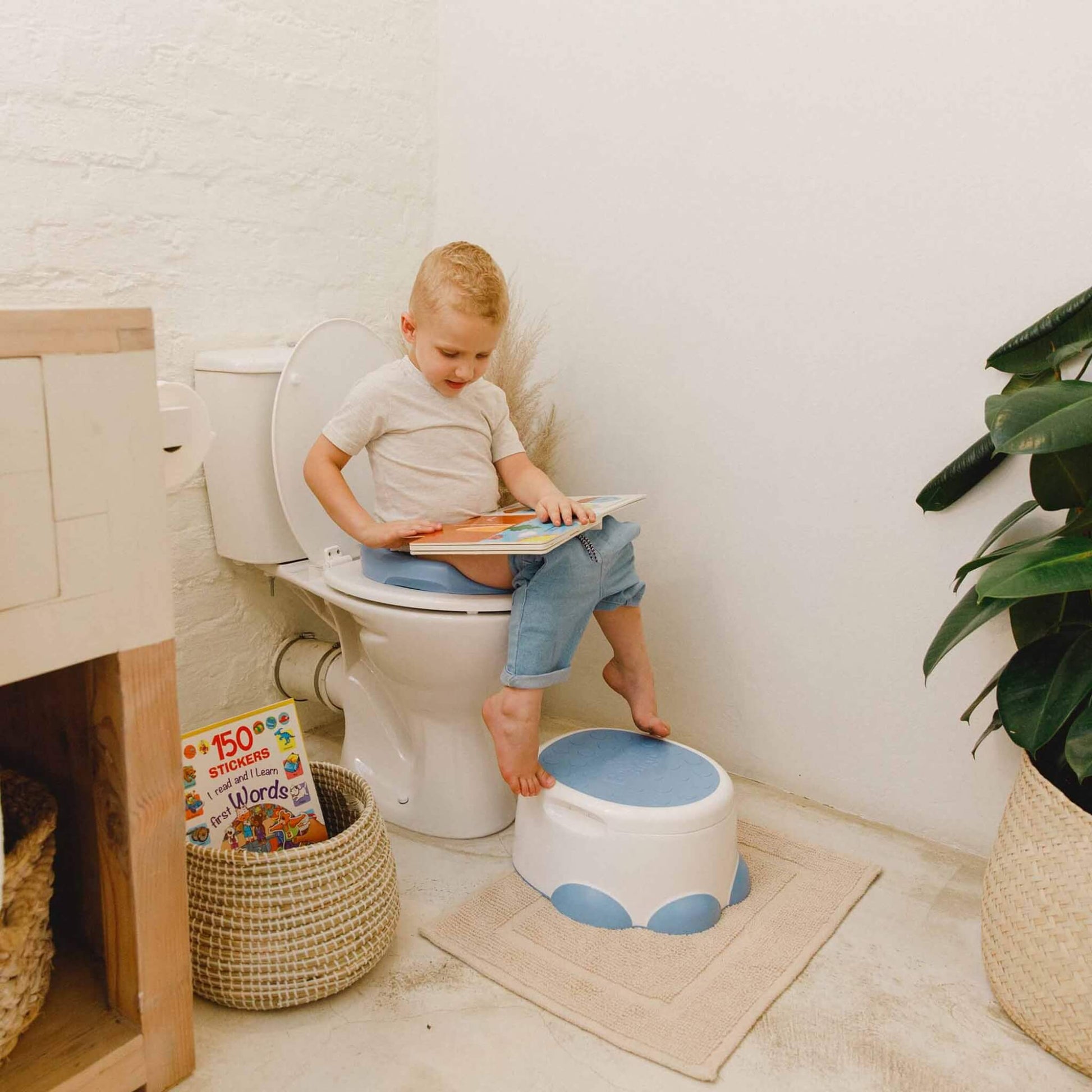 Young child using toilet trainer with Bumbo Step ‘n Potty as a supportive step.