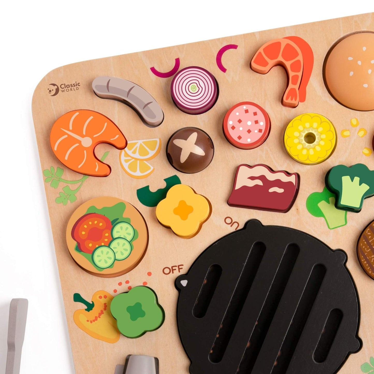 Close-up of wooden BBQ puzzle showing colourful food shapes including onion slice, sausage, prawn and corn with painted details.