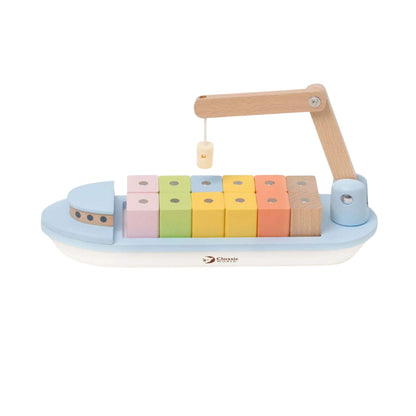Side view of a wooden cargo ship showing neat rows of pastel stacking blocks.