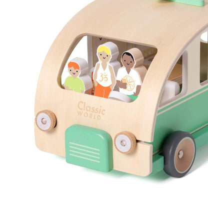 Close-up view through the campervan’s front window, showing three small wooden characters seated inside.