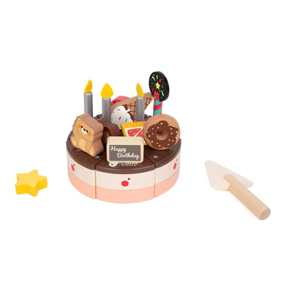 The Classic World Wooden Chocolate Cake,  with chocolate and pink layers, topped with removable candles, a bear, fruit slices, and donuts, shown with a wooden serving knife.