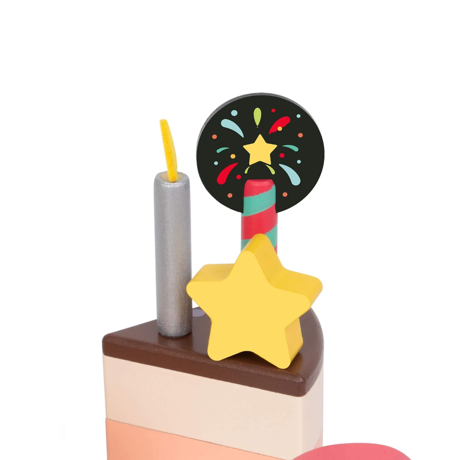 A single wooden cake slice decorated with a yellow star, silver candle, and black disc topper with a star and fireworks design.