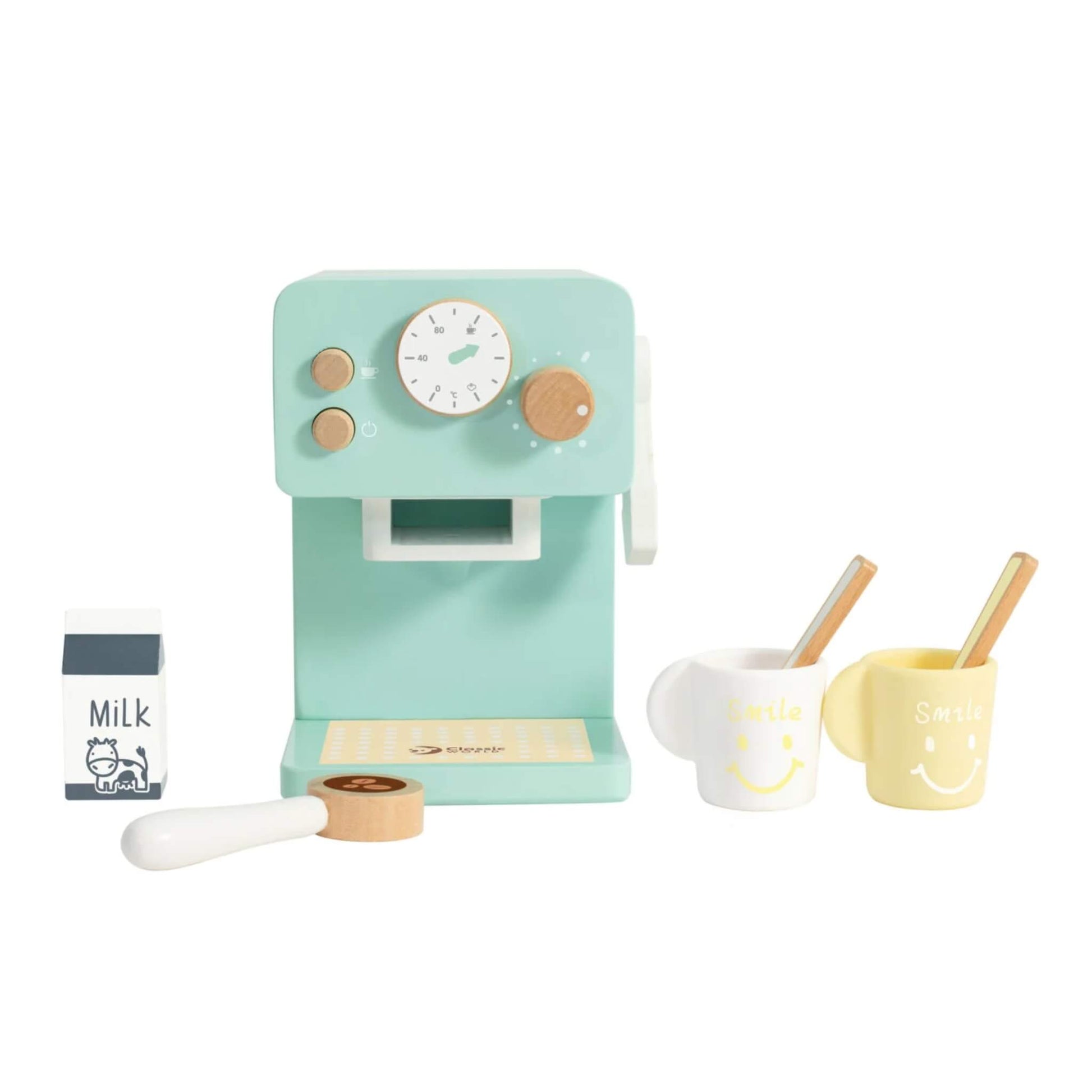 Classic World Coffee Maker set with mint green wooden machine, two smiling mugs, a milk carton, spoon, and coffee pod displayed neatly.
