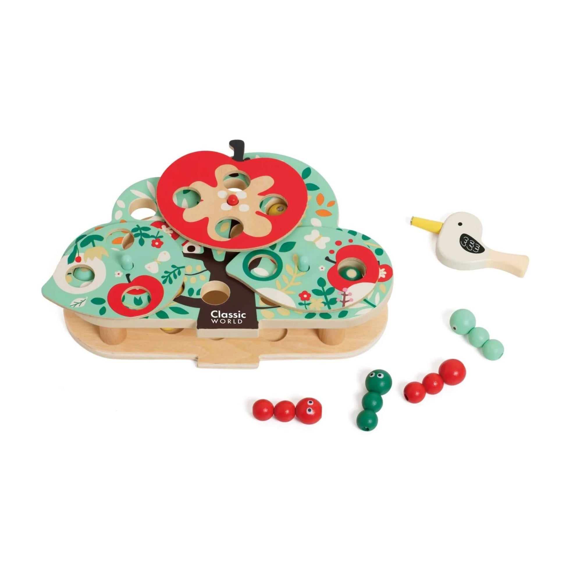 Wooden tree-shaped toy with red apple slice on top, scattered caterpillar pieces, and a small wooden bird tool placed to the side.
