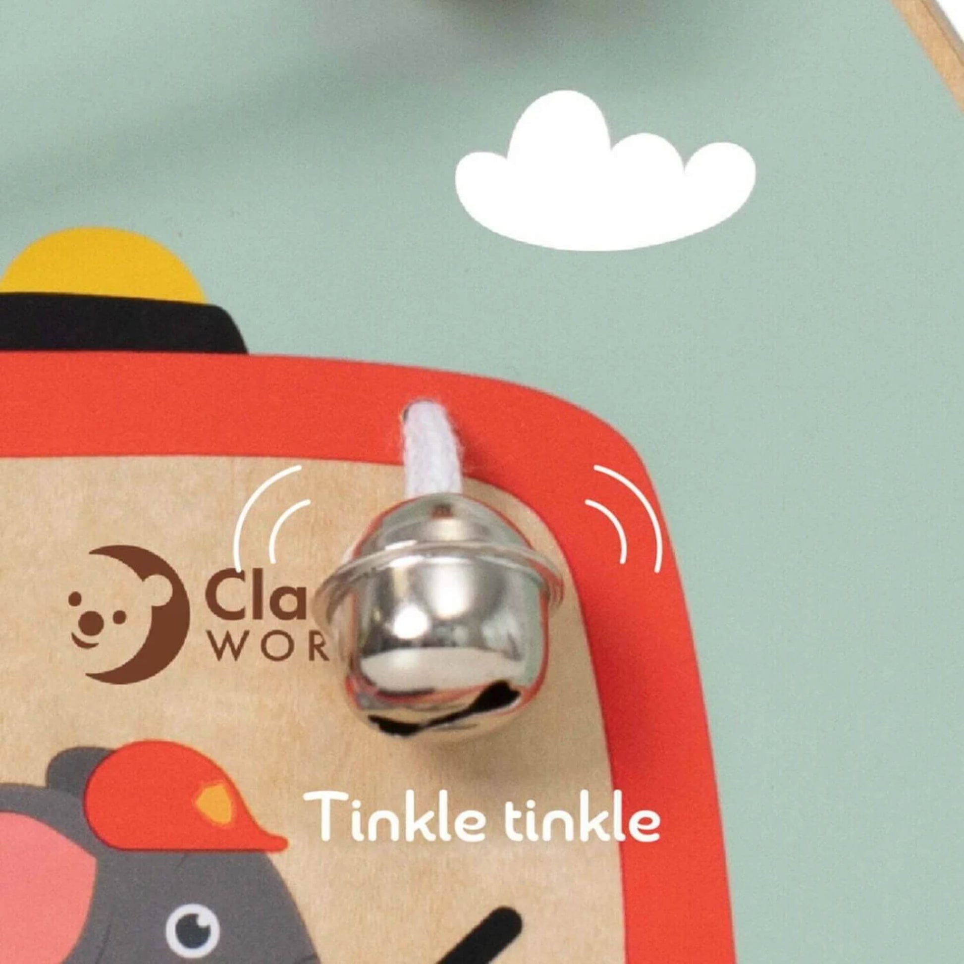 Close-up of the busy board’s silver bell, tied with string and ready to ring.