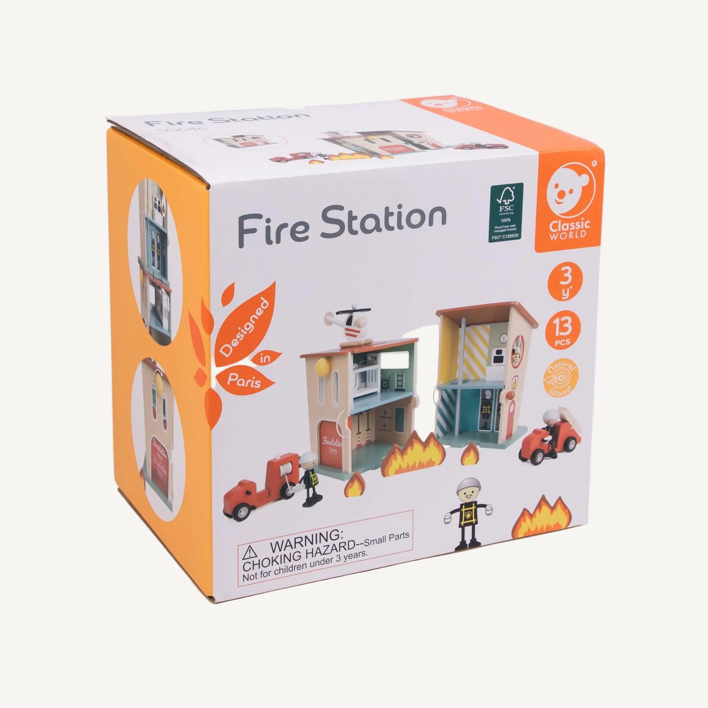 A product packaging box showing a wooden fire station play set with illustrated contents, age guidance and safety information.