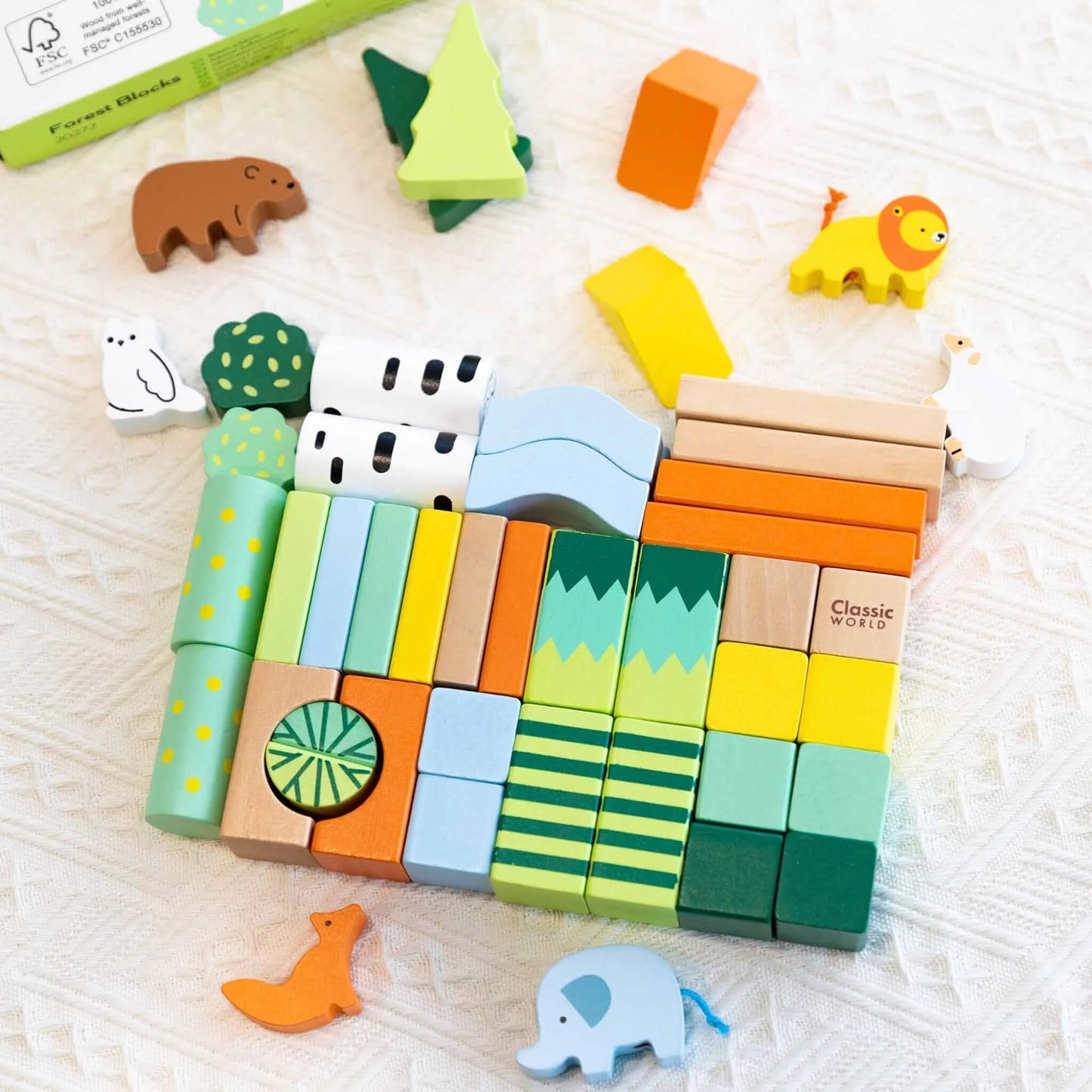 Top-down view of all 50 Classic World Forest Blocks neatly laid out, showing the variety of shapes, colours, and animal figures included in the set.