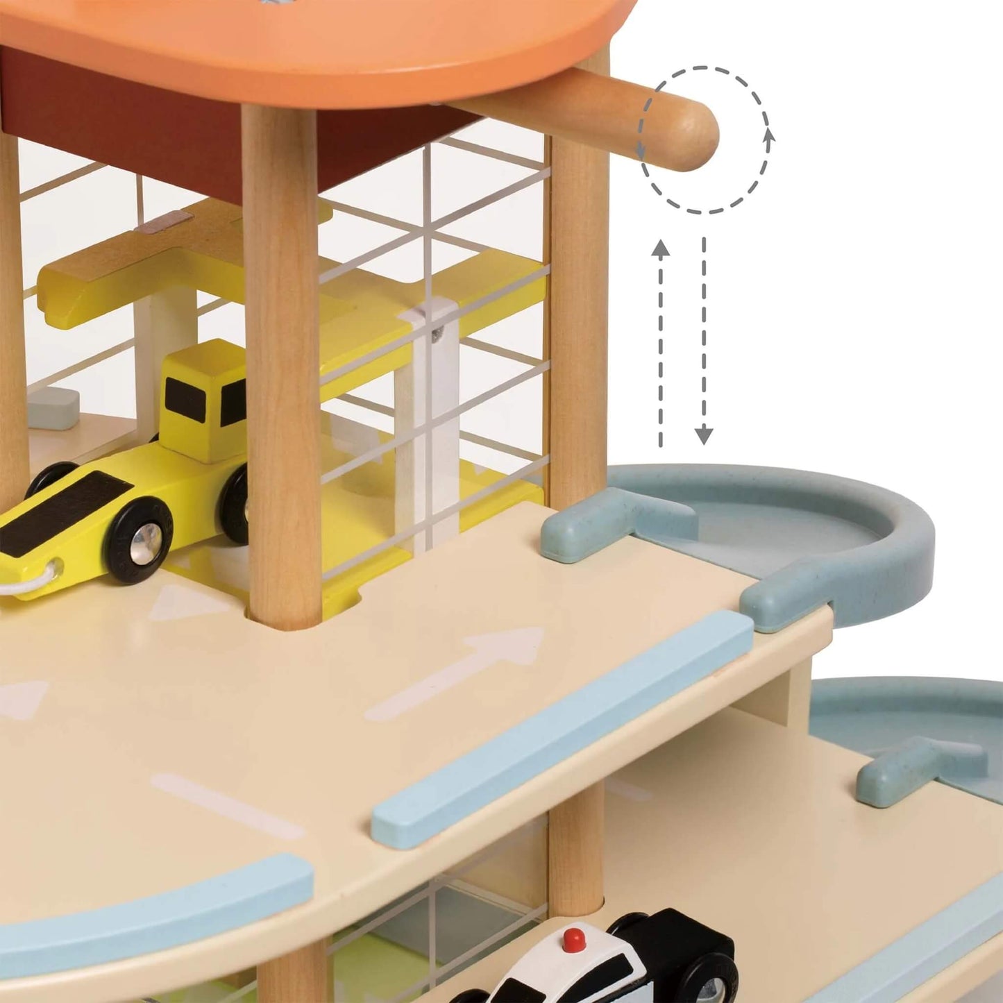 Close-up of a multi-level wooden garage showing a yellow tow truck inside the elevator and a spiral ramp beside it.