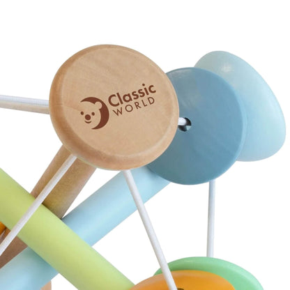 Close-up of a wooden sensory ball showing the Classic World logo on a natural wood disc, surrounded by pastel rods and beads.