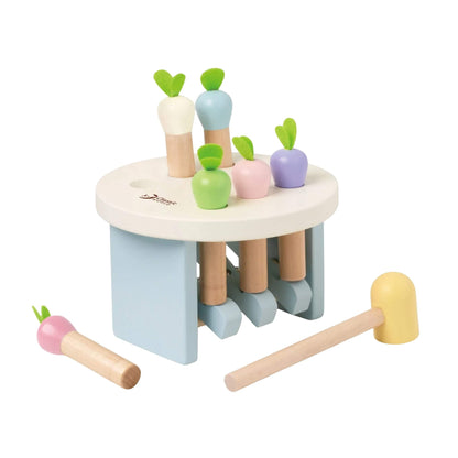 The Classic World Mara Pounding Game with image showing a wooden hammering toy with pastel radish shapes, a white circular top, blue frame, and a small wooden mallet.