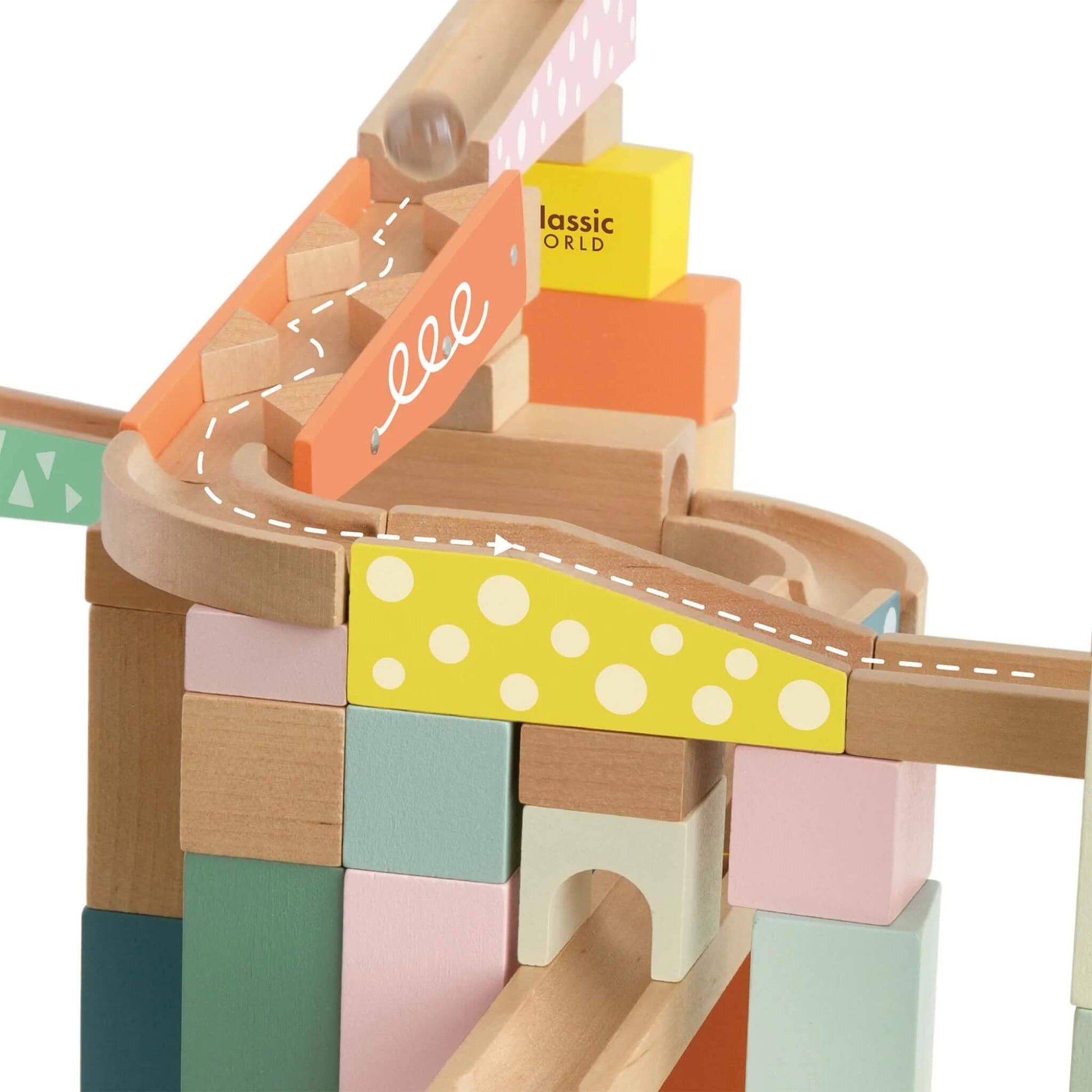 Detailed view of an orange marble run section with white swirls and patterned blocks.
