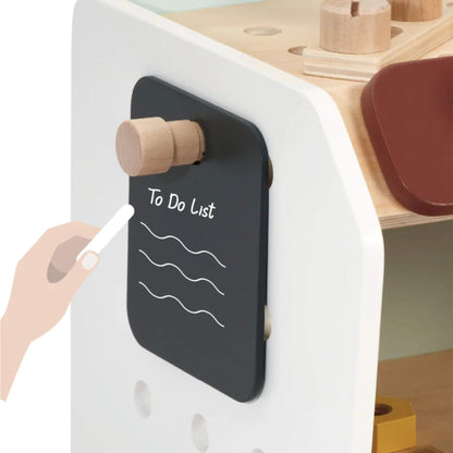 Side view of a wooden toy mini workbench showing small black chalkboard on side panel with “To Do List” written in white chalk.