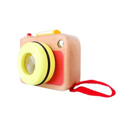 A wooden toy camera from Classic World, designed for small hands, featuring a yellow lens, red strap, and natural wood finish for playful role play.