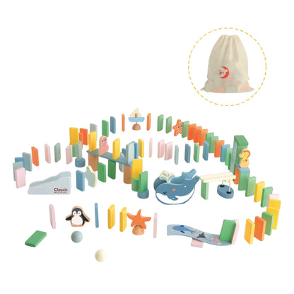 Complete ocean domino set laid out with pastel blocks, whale, penguin, seahorse, and various ramps, plus a storage bag shown in the corner.