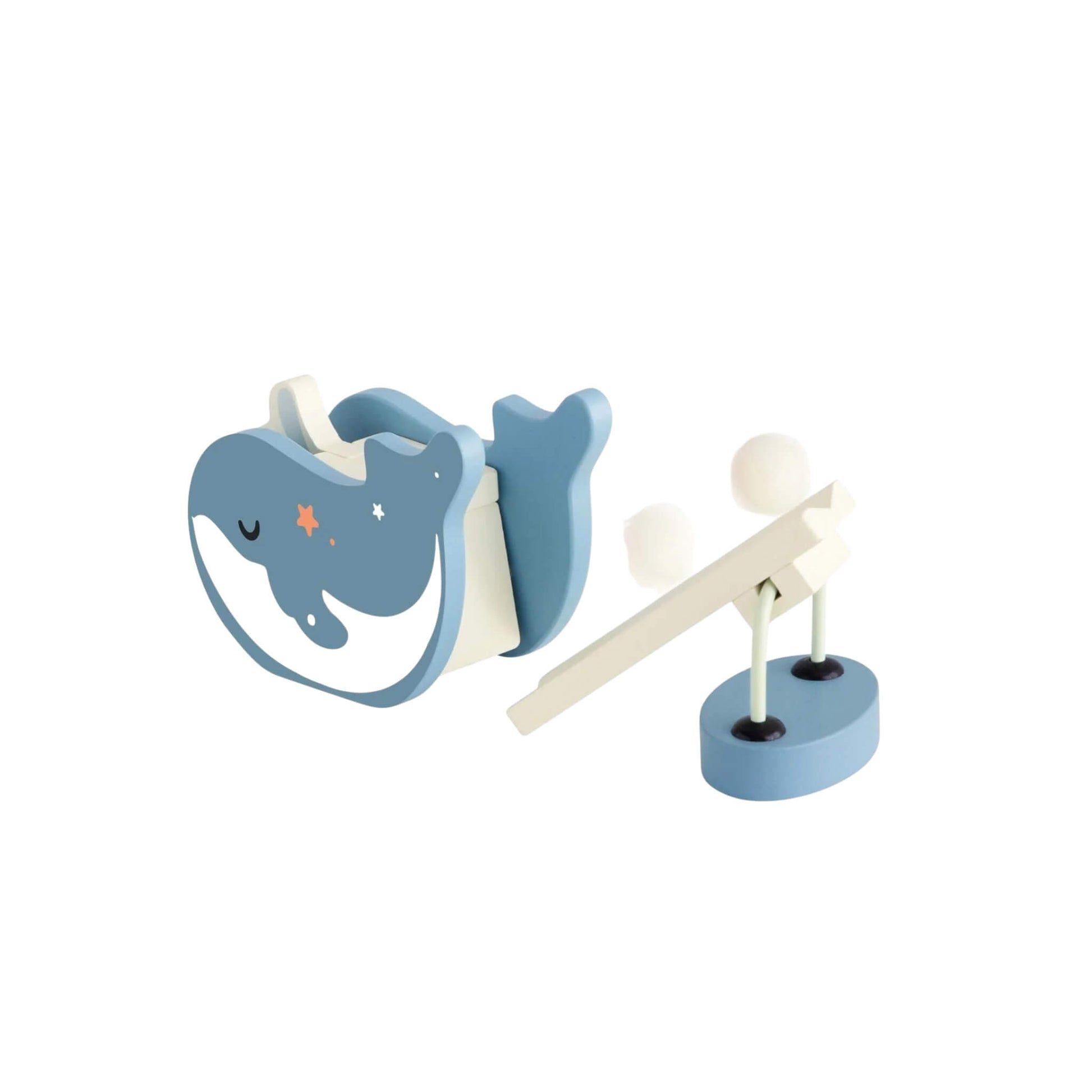 Close-up of a blue wooden whale figure and small launcher with balls, part of the ocean-themed domino play set.