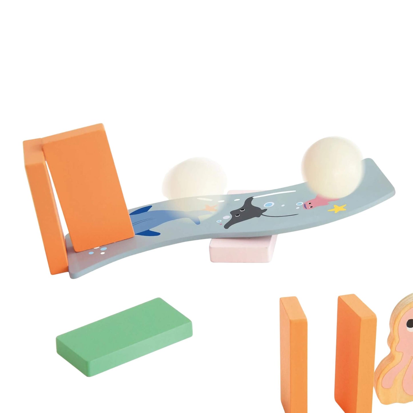 Curved ramp with sea life illustrations and two small white balls, part of the domino accessory pieces.