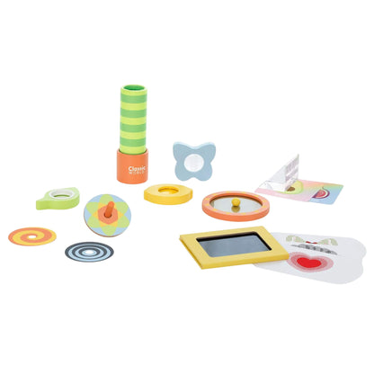 A colourful Classic World Optical Experiments set featuring a green striped kaleidoscope, spinning top with patterned discs, mirrors, lenses, and visual illusion cards arranged on a white background.