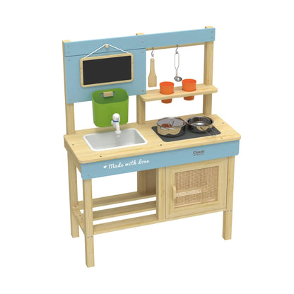 Side view of a wooden outdoor kitchen featuring a blue frame, white sink, green bucket, blackboard, metal pots, wooden spatula, ladle, and orange cups on shelves.