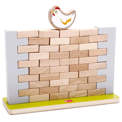 A jenga style wooden wall game made from light-coloured rectangular bricks stacked between two grey supports, with a painted wooden chicken figure perched on top.