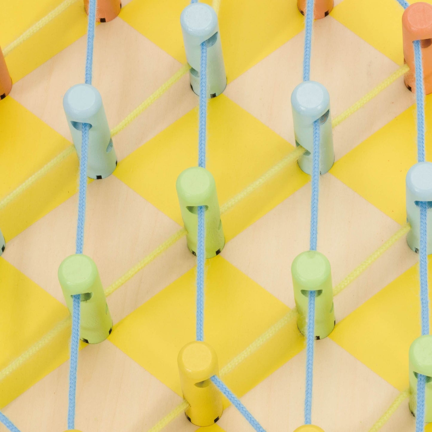 Close-up of a wooden Pineapple Linking Game showcasing colourful pegs and neatly threaded blue strings on a yellow chequered base.