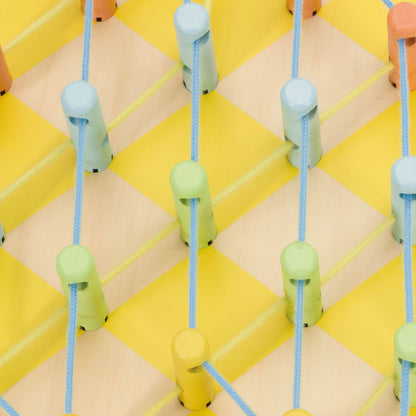 Close-up of a wooden Pineapple Linking Game showcasing colourful pegs and neatly threaded blue strings on a yellow chequered base.