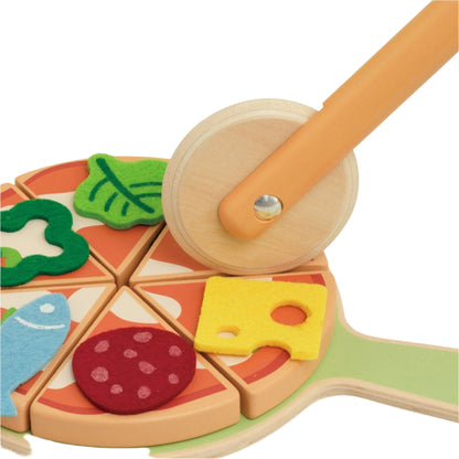 Close-up showing a toy wooden pizza cutter slicing through pizza pieces topped with colourful felt toppings.