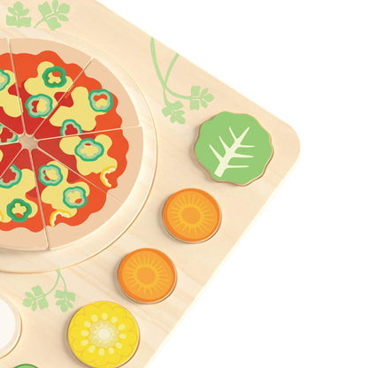 Close-up of wooden pizza puzzle with removable vegetable toppings including pepper, carrot and leafy greens.
