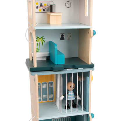 Wooden jail cell with figure inside and locker graphics, part of a multi-level police playset.