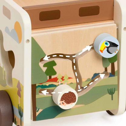 Detail of the truck’s side panel maze featuring wooden knobs with animal illustrations, moving along a tree-branch path.